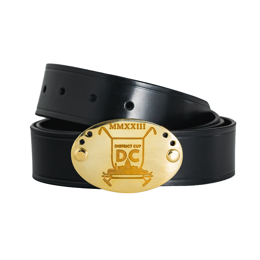 Black leather belt with gold belt buckle engraved with The District Cup logo